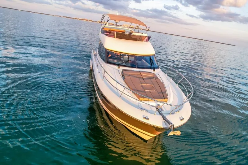 Slide: The Image of Luxury 2013 Prestige 500 yacht cruising on calm waters at sunset. - 17