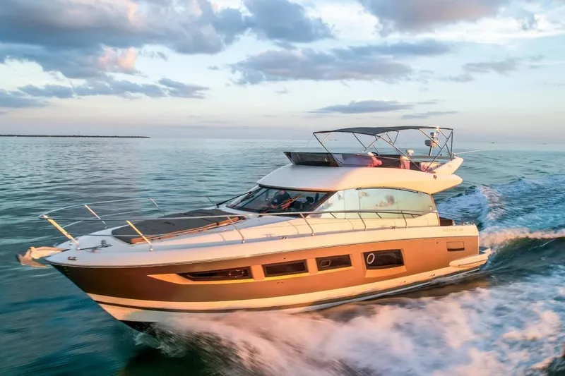 Slide: The Image of Luxury 2013 Prestige 500 yacht cruising on open water at sunset. - 2