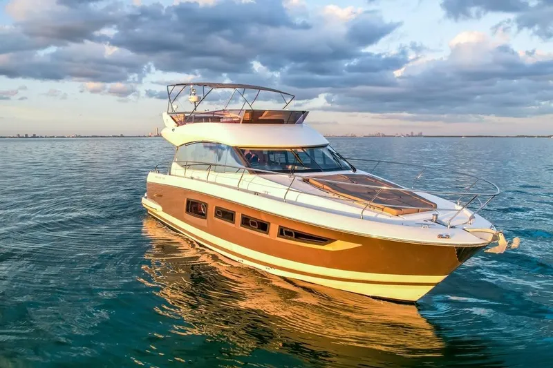 Slide: The Image of Luxury 2013 Prestige 500 yacht cruising on calm ocean waters at sunset. - 3