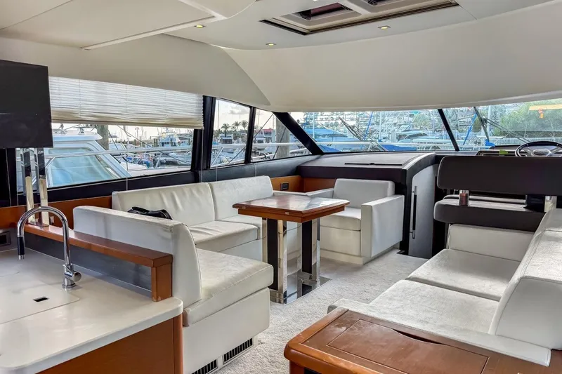 Slide: The Image of Luxurious interior of a 2013 Prestige 500 yacht with white seating and wooden accents. - 4