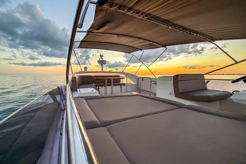 Slide: The Image of Luxurious 2013 Prestige 500 yacht at sunset, featuring spacious deck and elegant seating. - 8