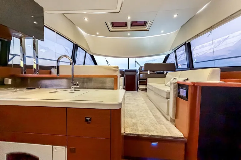 Slide: The Image of Luxurious interior of a 2013 Prestige 500 yacht with modern kitchen and seating area. - 9