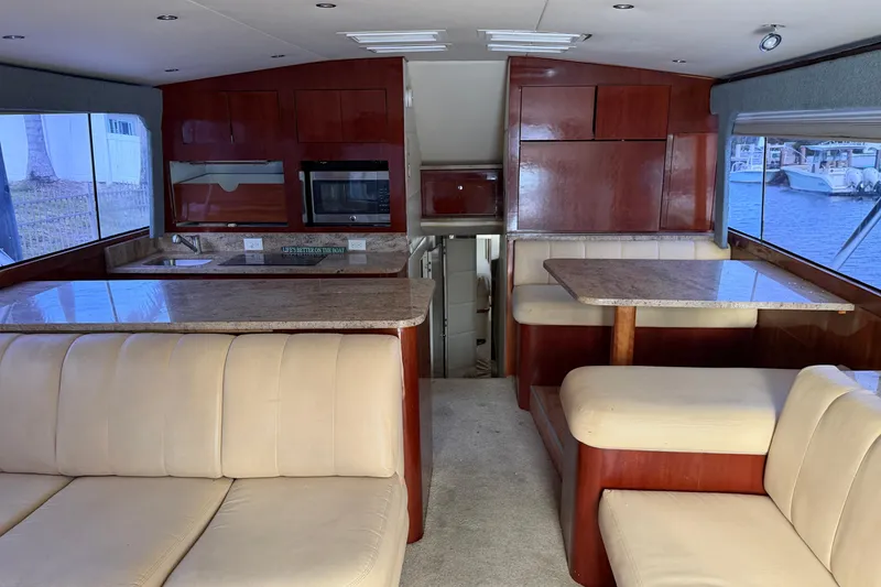 Slide: The Image of Interior of 1985 Ocean Yachts 55 Super Sport with beige seating and wooden cabinetry. - 10