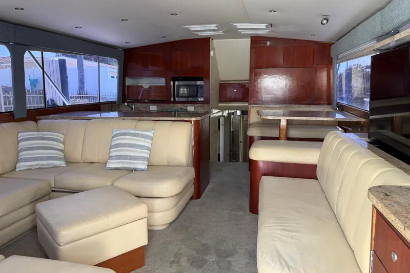 Slide: The Image of Luxurious interior of 1985 Ocean Yachts 55 Super Sport with beige seating and wooden accents. - 11