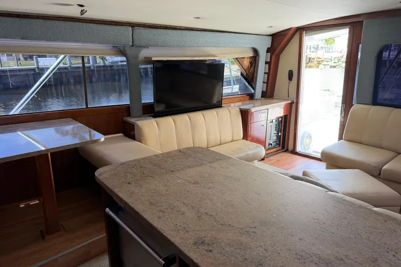 Slide: The Image of Luxurious interior of 1985 Ocean Yachts 55 Super Sport with plush seating and large windows. - 14