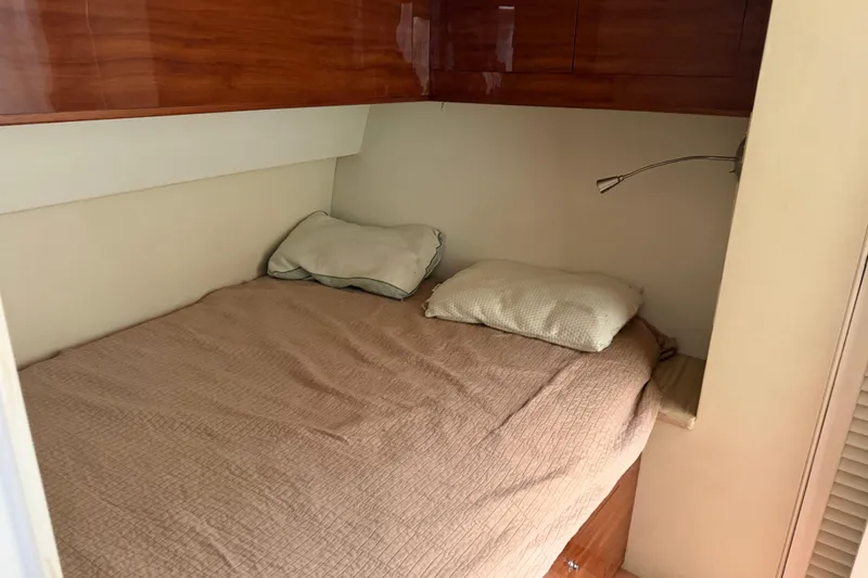 Slide: The Image of Cozy bedroom in 1985 Ocean Yachts 55 Super Sport with wooden cabinets and reading light. - 16