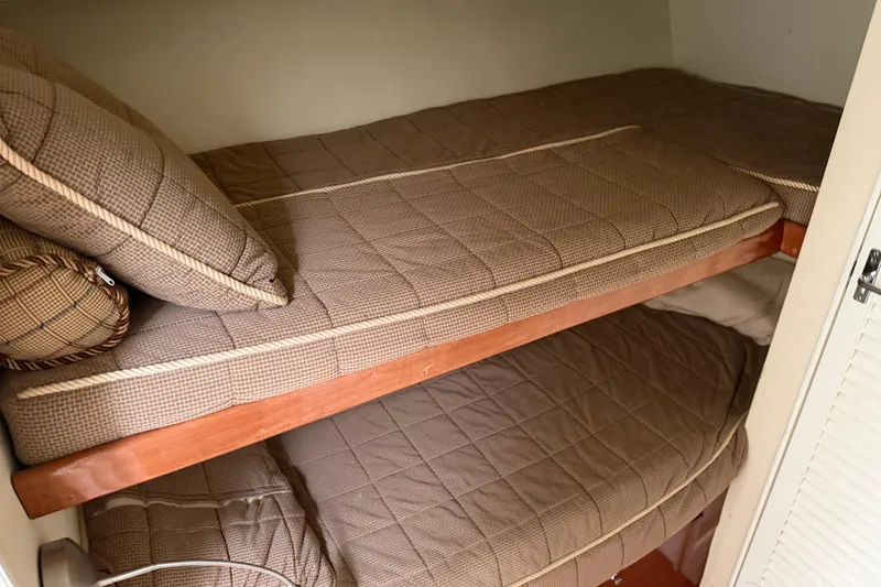 Slide: The Image of Bunk beds in 1985 Ocean Yachts 55 Super Sport, featuring brown checkered bedding. - 17