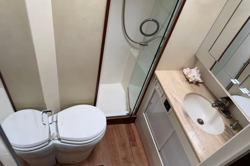 Slide: The Image of Bathroom interior of 1985 Ocean Yachts 55 Super Sport with shower, toilet, and sink. - 18