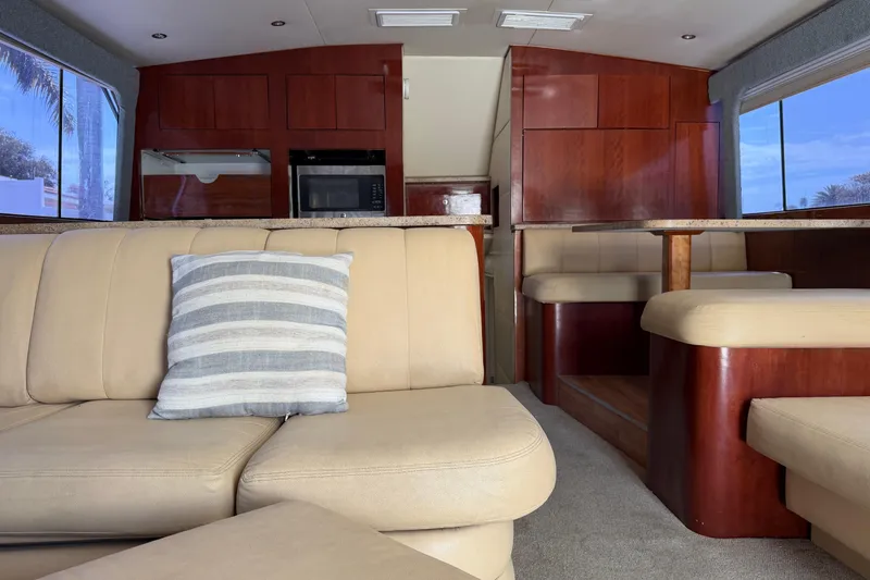 Slide: The Image of Luxurious interior of 1985 Ocean Yachts 55 Super Sport with beige seating and wooden cabinetry. - 21