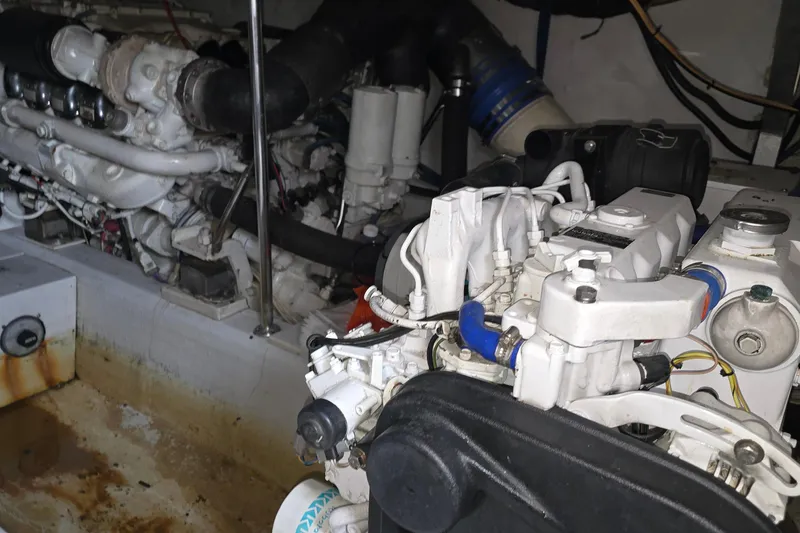 Slide: The Image of Engine room of a 1985 Ocean Yachts 55 Super Sport, showcasing mechanical components. - 22