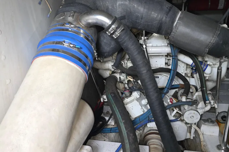 Slide: The Image of Engine compartment of a 1985 Ocean Yachts 55 Super Sport, featuring hoses and mechanical components. - 23