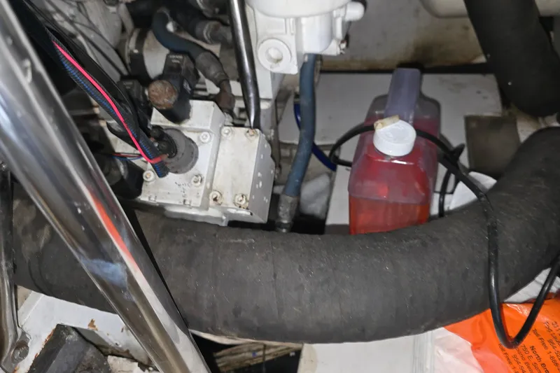 Slide: The Image of Engine compartment of a 1985 Ocean Yachts 55 Super Sport with visible hoses and components. - 24