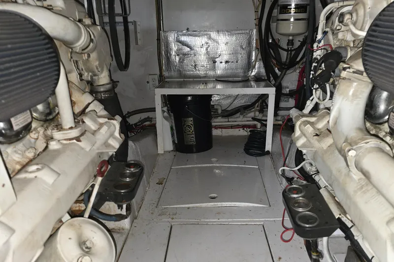 Slide: The Image of Engine room of a 1985 Ocean Yachts 55 Super Sport, showcasing mechanical components. - 26