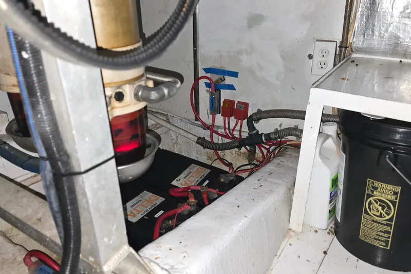 Slide: The Image of Engine room of 1985 Ocean Yachts 55 Super Sport with batteries and wiring. - 28