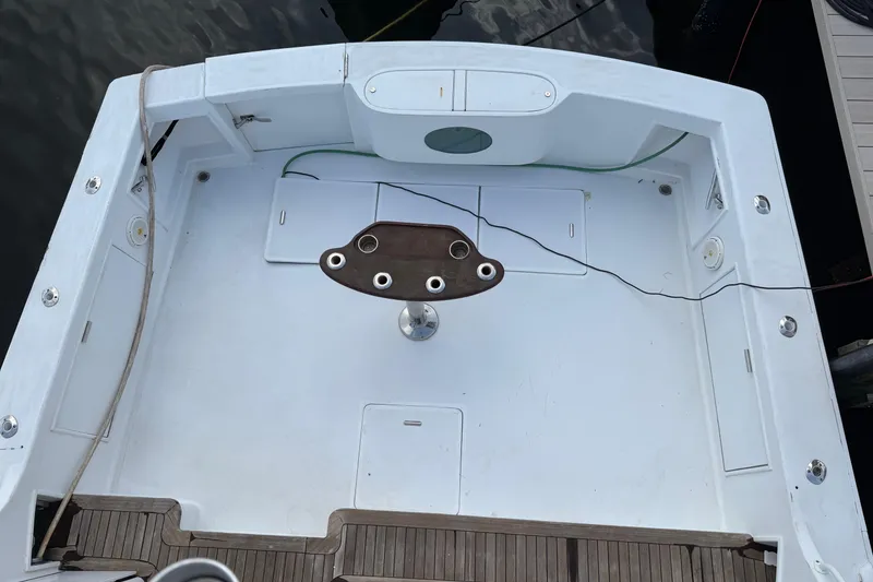 Slide: The Image of 1985 Ocean Yachts 55 Super Sport deck with fishing rod holders and storage compartments. - 4