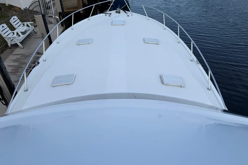 Slide: The Image of 1985 Ocean Yachts 55 Super Sport yacht deck view by the water. - 5