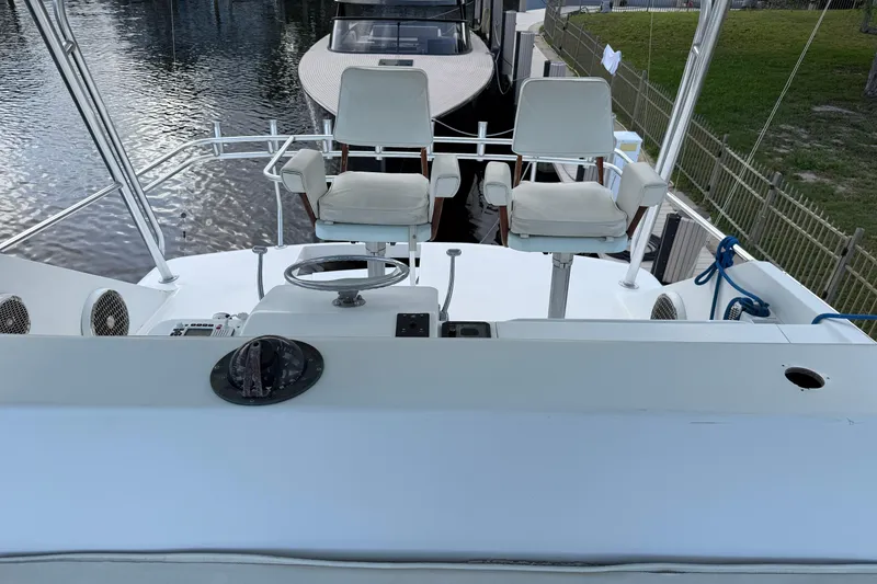 Slide: The Image of 1985 Ocean Yachts 55 Super Sport helm with dual captain chairs and steering wheel. - 6