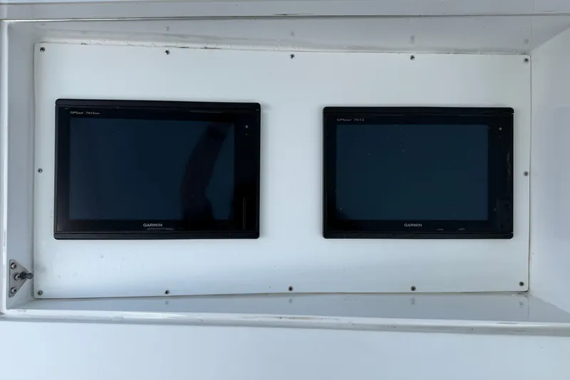 Slide: The Image of Dual Garmin GPS displays on 1985 Ocean Yachts 55 Super Sport boat dashboard. - 8