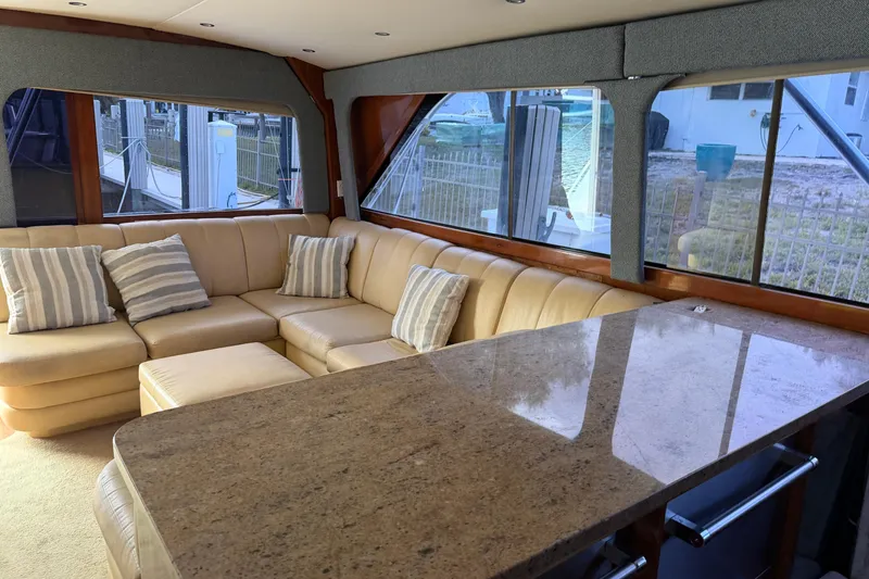 Slide: The Image of Luxurious interior of 1985 Ocean Yachts 55 Super Sport with beige leather seating and granite table. - 9