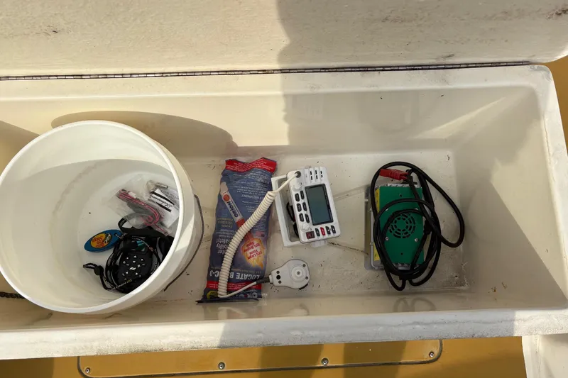 Slide: The Image of Storage compartment of 1979 Mako Pro Skiff 21 CC with fishing gear and electronics. - 12