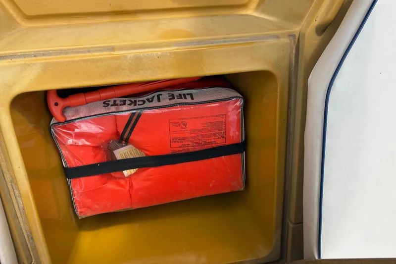 Slide: The Image of Storage compartment with life jackets on a 1979 Mako Pro Skiff 21 CC boat. - 14