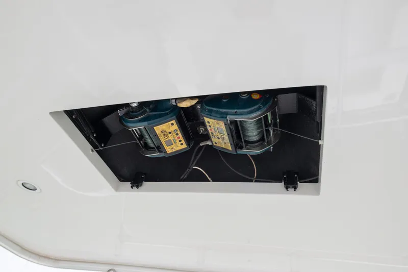 Slide: The Image of 2005 Cabo 40 Flybridge boat equipment compartment with visible wiring and machinery. - 10