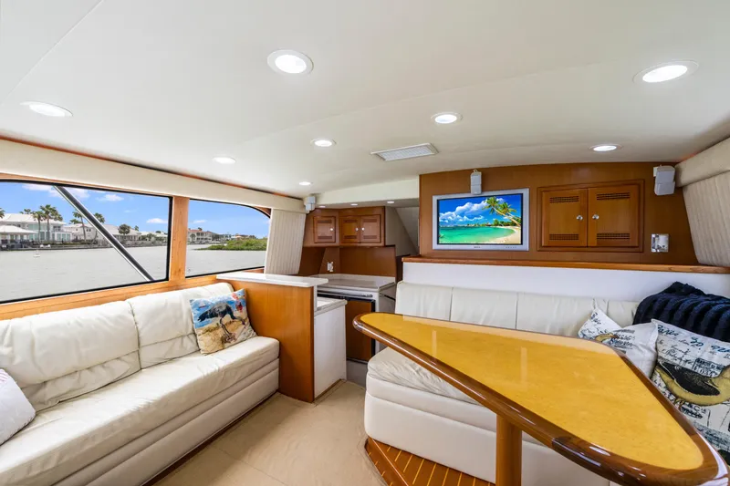 Slide: The Image of Luxurious interior of 2005 Cabo 40 Flybridge yacht with plush seating and scenic window views. - 18