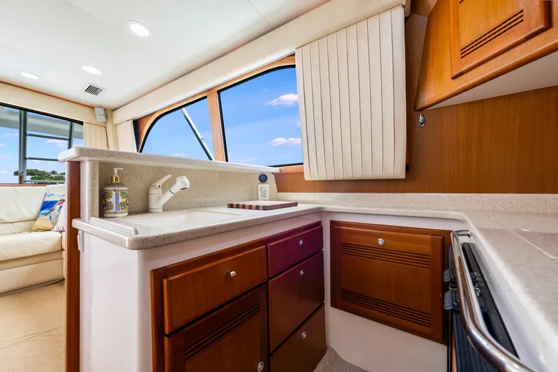 Slide: The Image of Luxurious interior of 2005 Cabo 40 Flybridge yacht with modern kitchen amenities. - 22