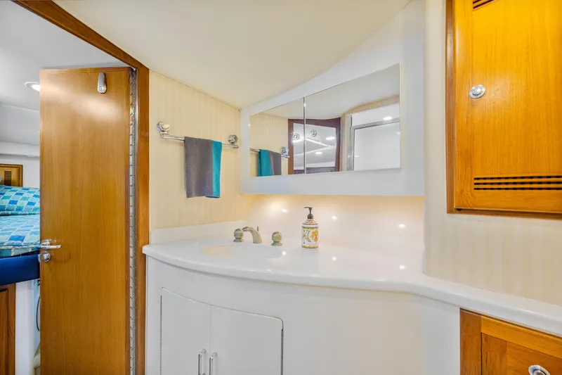 Slide: The Image of Luxurious bathroom interior of 2005 Cabo 40 Flybridge yacht with wooden accents. - 28