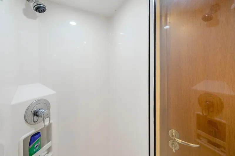 Slide: The Image of Shower area inside 2005 Cabo 40 Flybridge yacht, featuring sleek design and modern fixtures. - 29