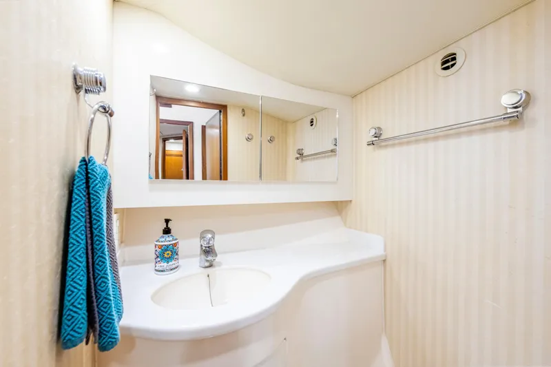 Slide: The Image of Luxurious bathroom in 2005 Cabo 40 Flybridge yacht with modern fixtures and elegant design. - 31