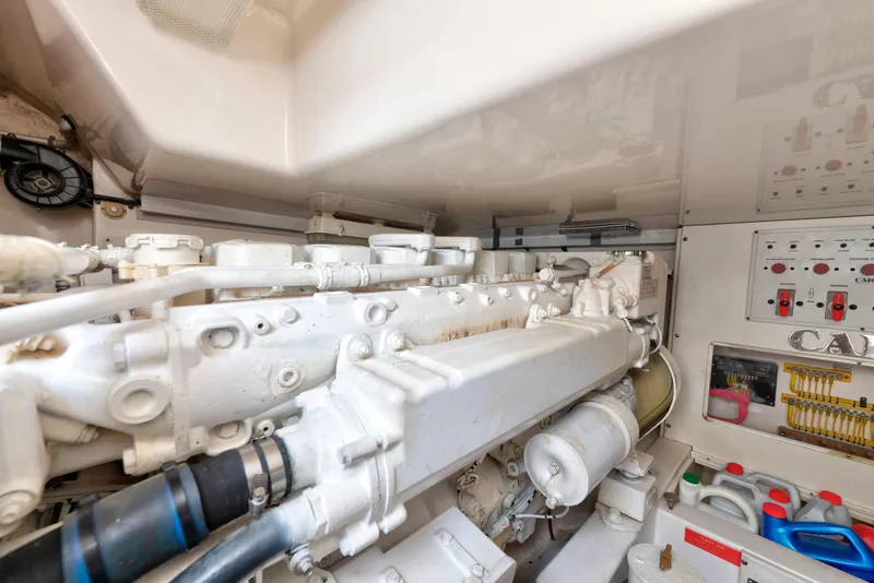 Slide: The Image of Engine room of a 2005 Cabo 40 Flybridge yacht, showcasing machinery and control panels. - 33