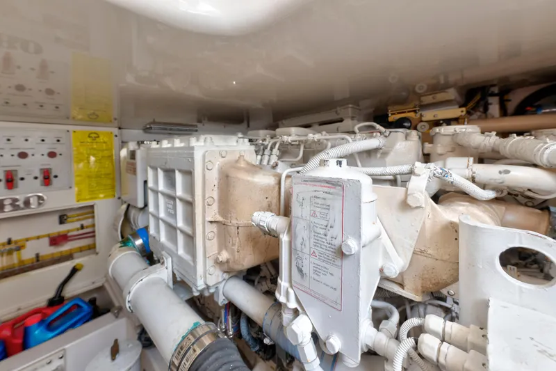 Slide: The Image of Engine room of a 2005 Cabo 40 Flybridge yacht, showcasing mechanical components. - 34