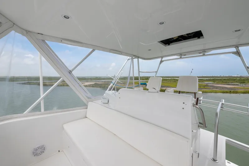 Slide: The Image of 2005 Cabo 40 Flybridge interior with scenic water and land view. - 8