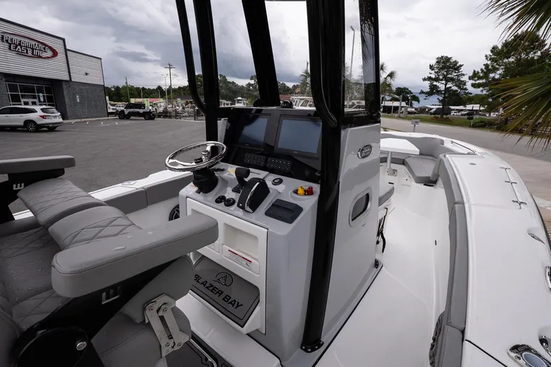 Slide: The Image of 2026 Blazer Bay Makaira 2600 boat interior with steering console and seating. - 10