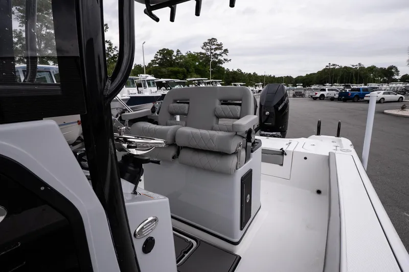 Slide: The Image of 2026 Blazer Bay Makaira 2600 boat interior with cushioned seating and control console. - 12