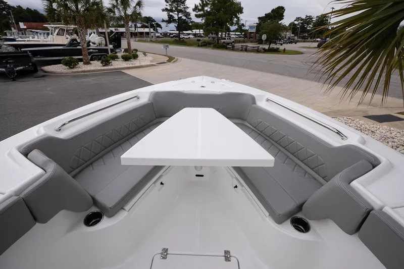 Slide: The Image of 2026 Blazer Bay Makaira 2600 boat interior with gray seating and white table. - 18