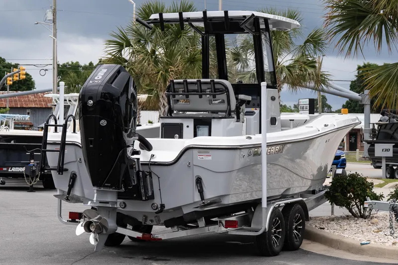 Slide: The Image of 2026 Blazer Bay Makaira 2600 boat on trailer, parked near palm trees. - 6
