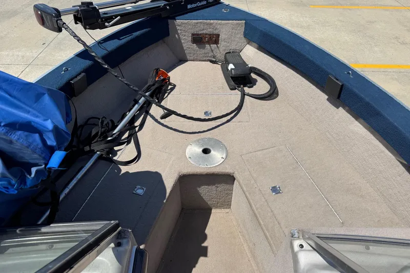 Slide: The Image of 1997 Starcraft Stardeck 190 Fish boat interior with trolling motor and storage compartments. - 10