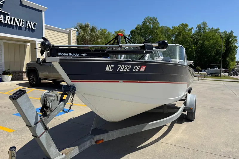 Slide: The Image of 1997 Starcraft Stardeck 190 Fish boat on trailer outside marine store. - 12
