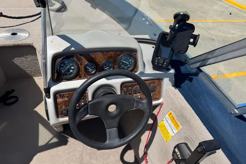 Slide: The Image of 1997 Starcraft Stardeck 190 Fish boat dashboard with steering wheel and gauges. - 6