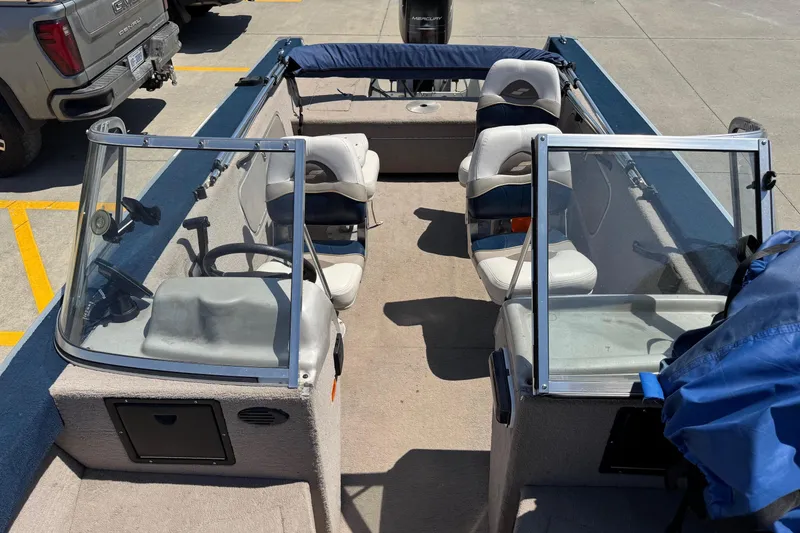 Slide: The Image of 1997 Starcraft Stardeck 190 Fish boat interior with seating and steering console. - 7