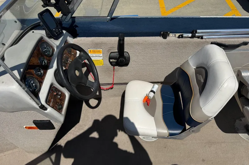 Slide: The Image of 1997 Starcraft Stardeck 190 Fish boat cockpit with steering wheel and seat. - 8