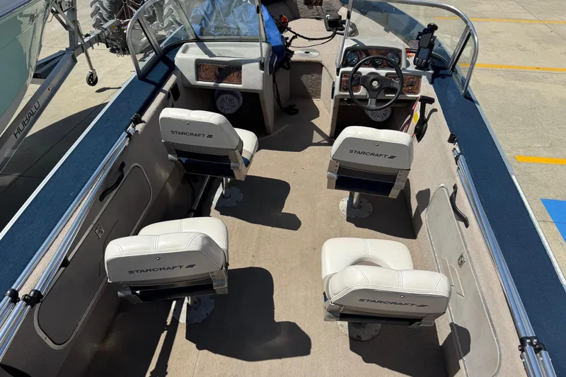 Slide: The Image of 1997 Starcraft Stardeck 190 Fish boat interior with four seats and steering console. - 9