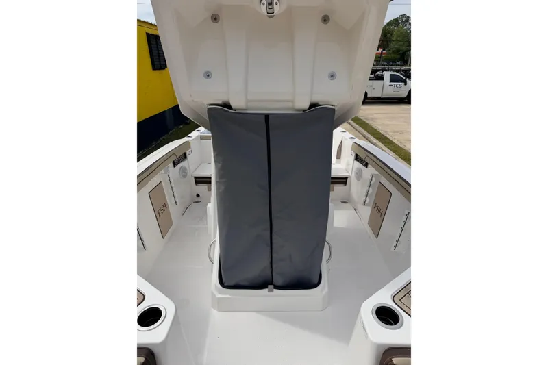 Slide: The Image of 2026 Yamaha Boats 222 FSH Sport interior with storage compartment open. - 10