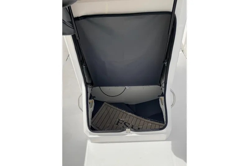 Slide: The Image of 2026 Yamaha Boats 222 FSH Sport interior storage compartment with open hatch. - 11
