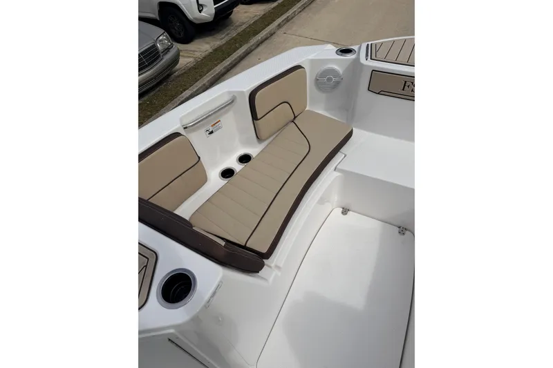 Slide: The Image of 2026 Yamaha Boats 222 FSH Sport interior seating with beige cushions and cup holders. - 13