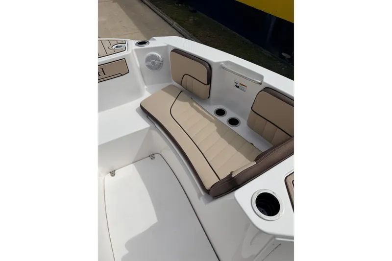 Slide: The Image of 2026 Yamaha Boats 222 FSH Sport interior with beige seating and cup holders. - 14