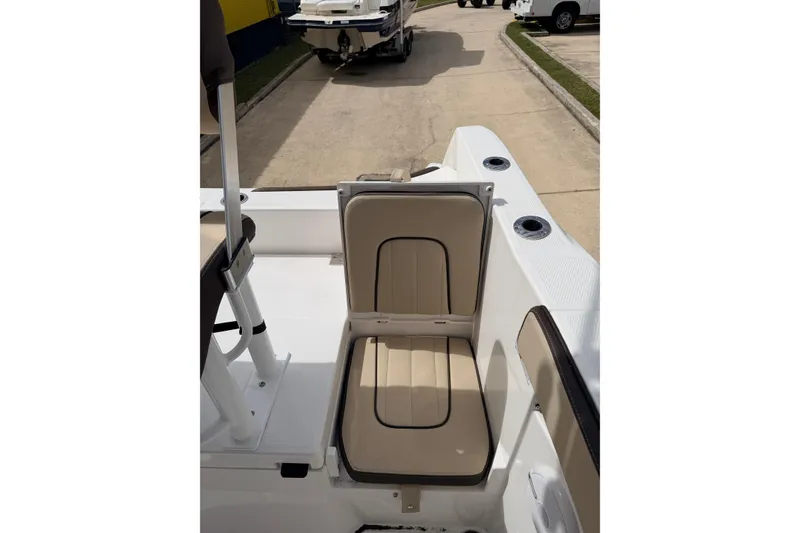 Slide: The Image of 2026 Yamaha Boats 222 FSH Sport interior seating detail, showcasing beige upholstery. - 15