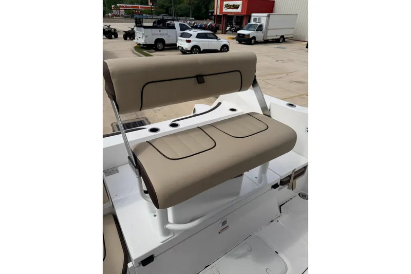 Slide: The Image of 2026 Yamaha Boats 222 FSH Sport beige seating, outdoor setting, dealership background. - 16